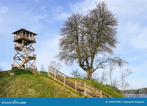 A Wooden Bird Watching Tower On Top Of A Hill By The Lake Stock Photo