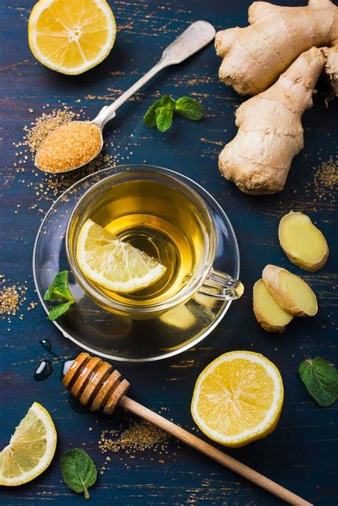 Cup Of Ginger Tea With Lemon And Honey On Dark Blue