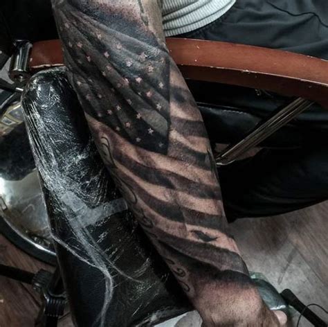 This american flag is meant to look like the ir flags that soldiers where into combat. 10 Mysterious American Flag Tattoos - POP TATTOO