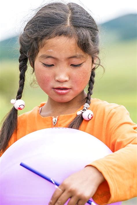 Portrait Of A Mongolian Nomadic Girl With Braids North Hangay Province