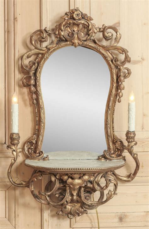 Additionally, both the sides have straight square pillars to support the central mirror. Vintage Italian Rococo Lighted Vanity Mirror at 1stdibs
