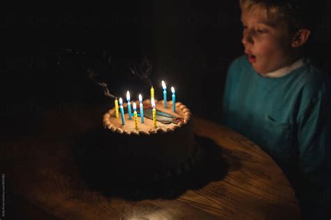 Boy Blowing Out The Candles On A Birthday Cake Del Colaborador De