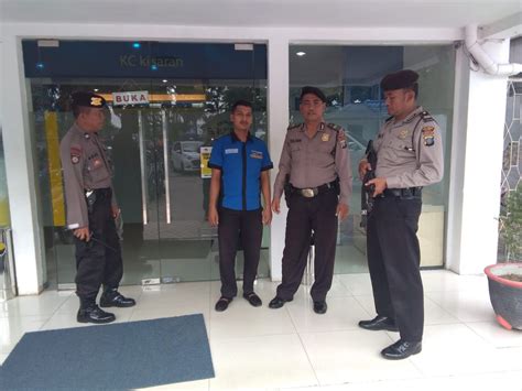 Three Police Officers Standing In Front Of An Entrance