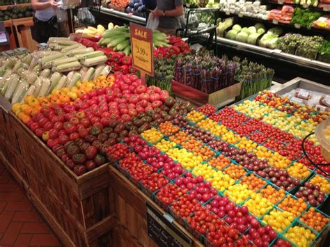 An Open Market With Lots Of Fruits And Vegetables On Display In Its Stands