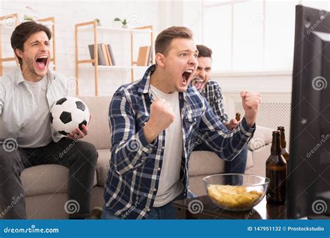 We Win Emotional Football Fans Watching Match On Tv Stock Photo