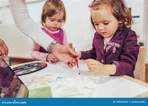 Happy Little Girl Preschooler Painting With Water Color Stock Image