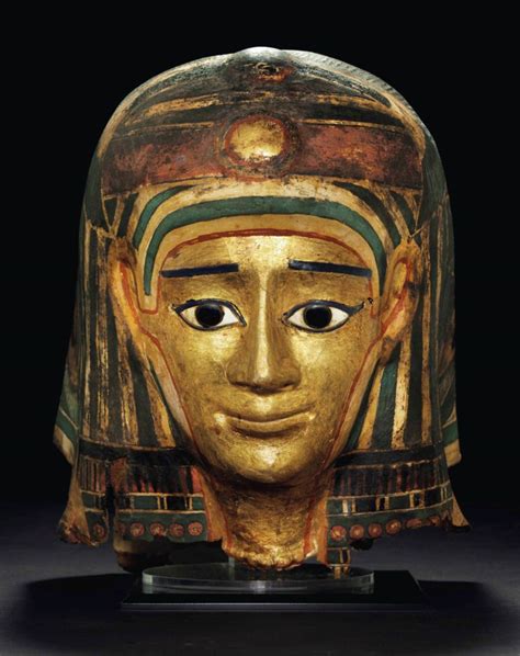 An Egyptian Gilt Cartonnage Mummy Mask