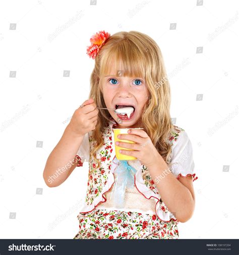 Little Girl Eating Yogurt Isolated On White Background Stock Photo