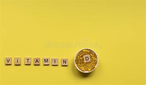 Yellow Capsules In The Round Bowl And The Word Vitamin D From Wooden Cubes Stock Image Image
