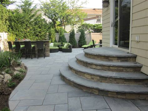 Gravel may be used to cover large areas of backyard spaces to give them a more natural feel. Custom Masonry | Patios Stoops & Walkways Landscape Design ...