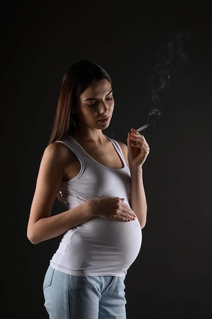 Premium Photo Pregnant Woman Smoking Cigarette On Black Background