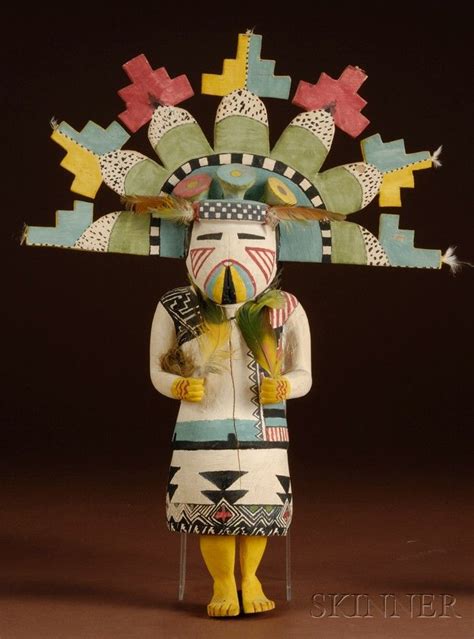 A Native American Doll Wearing A Colorful Headdress And Holding A Bird