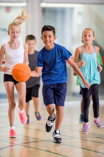 Children Playing Basketball At The Gym Stock Photo Download Image Now