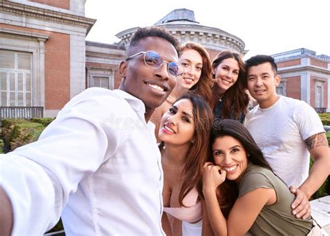 Group Of Multiracial Friends Smiling While Taking A Selfie Together Outdoors Stock Image