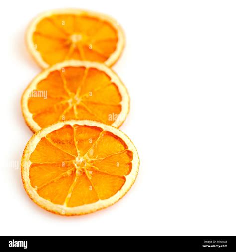 Three Dried Orange Slices From Above On White Background Stock Photo