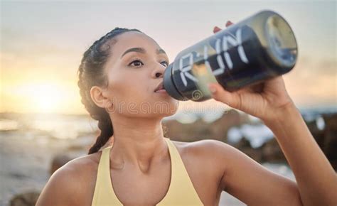 Health Fitness And Woman Drinking Water At Beach After Running