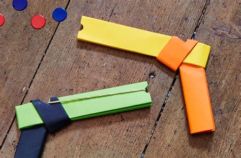 4 sheets of paper, scotch tape and small elastic (used to make bracelets). How to make a paper gun that shoots - goodtoknow
