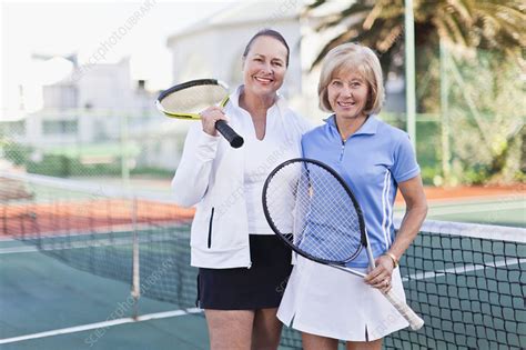 older women with tennis rackets on court stock image f004 4677 science photo library