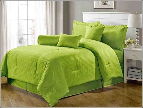 Bright Green Bedding In A Bedroom With Hardwood Floors