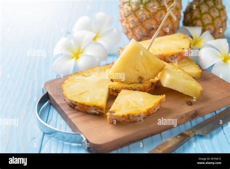 Fresh Sliced Pineapple On Wood Block And Blue Wood Background Summer