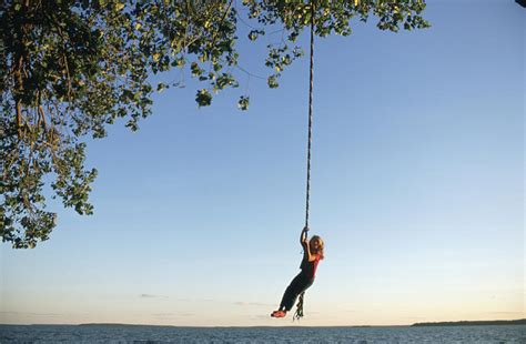 A Young Girls Swings On A Rope Swing Photograph By Joel Sartore