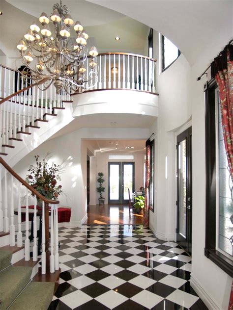Elegant Foyer With White Staircase And Checkerboard Floor