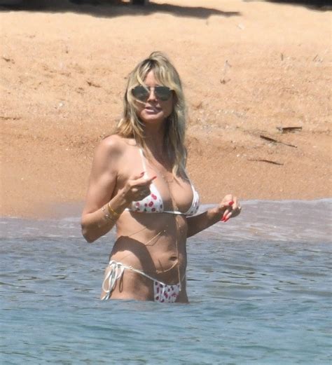 agt s heidi klum shows off her bare bottom in a tiny thong bikini as she holds hands with