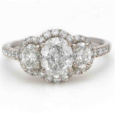This classical three stone diamond engagement ring is inspired by passion coupled with a sense of elegance. Three Stone Oval Engagement Rings - Wedding and Bridal Inspiration