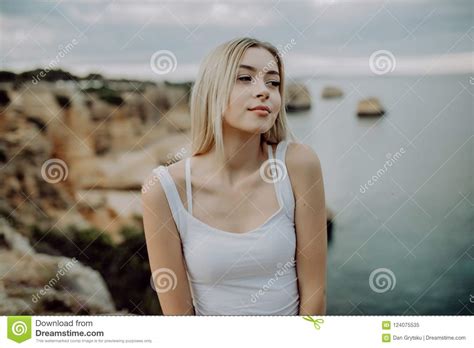portrait of attractive woman posing on rocky beach with beauty landscape stock image image of