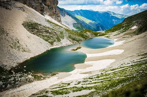 Lake Between Green Mountains · Free Stock Photo