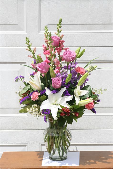Lavender Pink And White Flowers Including Roses And Lilies Arranged
