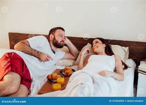 husband and wife wake up in the morning in the bedroom weekend breakfast in bed stock image