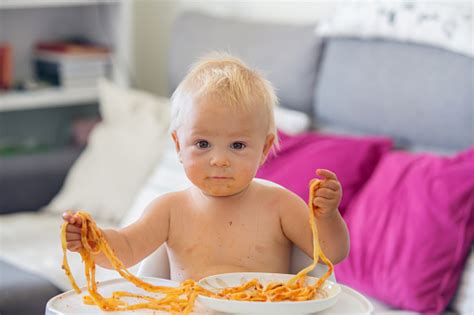 Sweet One Years Old Baby Boy Eating Pasta At Home Kid Eats Spaghetti