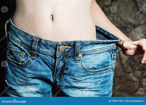 Woman Shows Weight Loss By Wearing Old Jeans Stock Photo Image Of