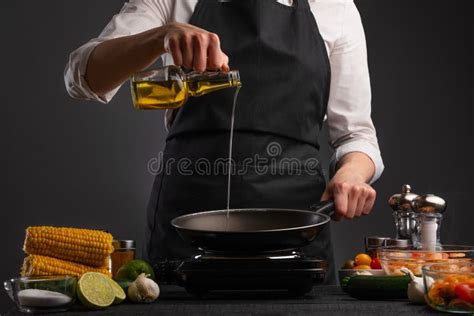 Chef Pouring Olive Oil For Frying Seafood With Vegetables Freezing In