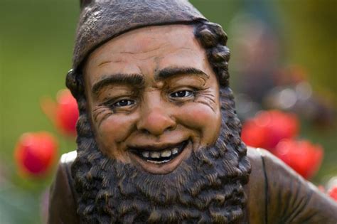 A Close Up Of A Statue Of A Man With A Beard And Wearing A Hat