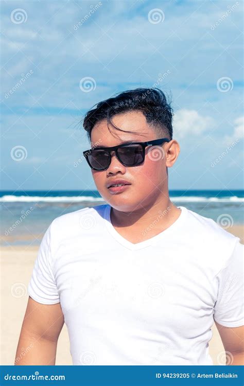 Young Asian Indonesian Man On The Beach Of Tropical Bali Island