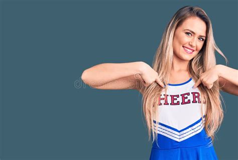 Young Beautiful Blonde Woman Wearing Cheerleader Uniform Looking Confident With Smile On Face
