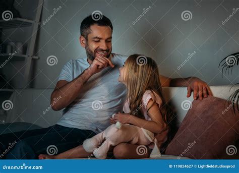 Father Playing With Little Daughter While Resting On Sofa Stock Image Image Of Emotional