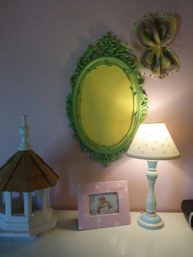 A Table With A Lamp Mirror And Pictures On It
