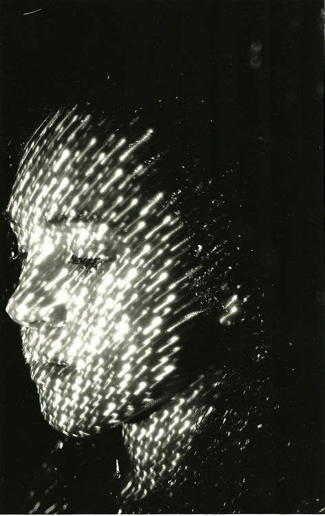 A Black And White Photo Of A Womans Face With Light Shining Through Her Hair