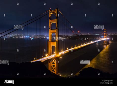 Golden Gate Bridge At Night With The San Francisco Skyline In The
