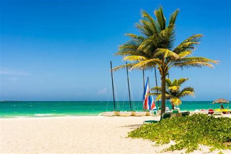 The Tropical Beach Of Varadero In Cuba With Coconut Palms And Colorful