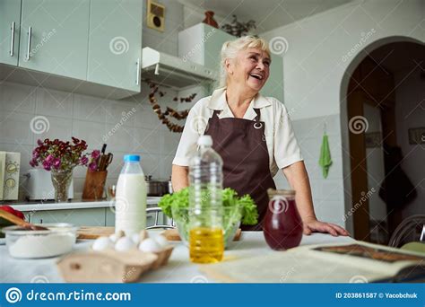 Cheerful Senior Woman Cooking Dinner In Kitchen Stock Image Image Of