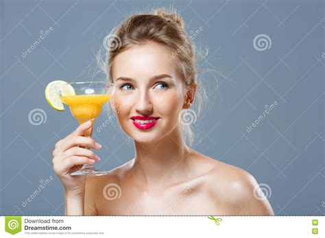 Beautiful Blonde Naked Girl Smiling Holding Cocktail Over Grey