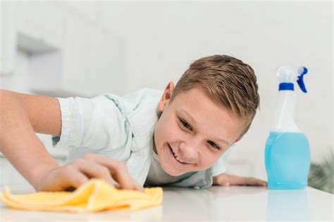 Free Photo Smiley Boy Cleaning Table With Rag