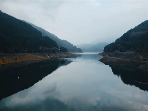 A Lake Between Mountains Under The Cloudy Day · Free Stock Photo