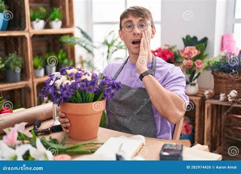 Caucasian Blond Man Working At Florist Shop Afraid And Shocked