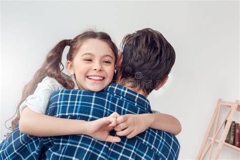 Father And Little Daughter At Home Standing Hugging Daughter Close Up