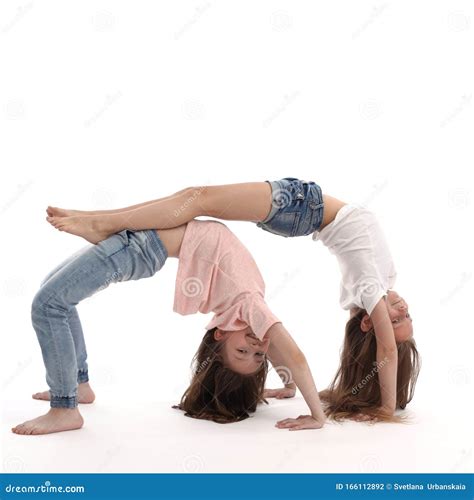 Two Girls Do Gymnastics At Home They Have Fun In Their Free Time Stock